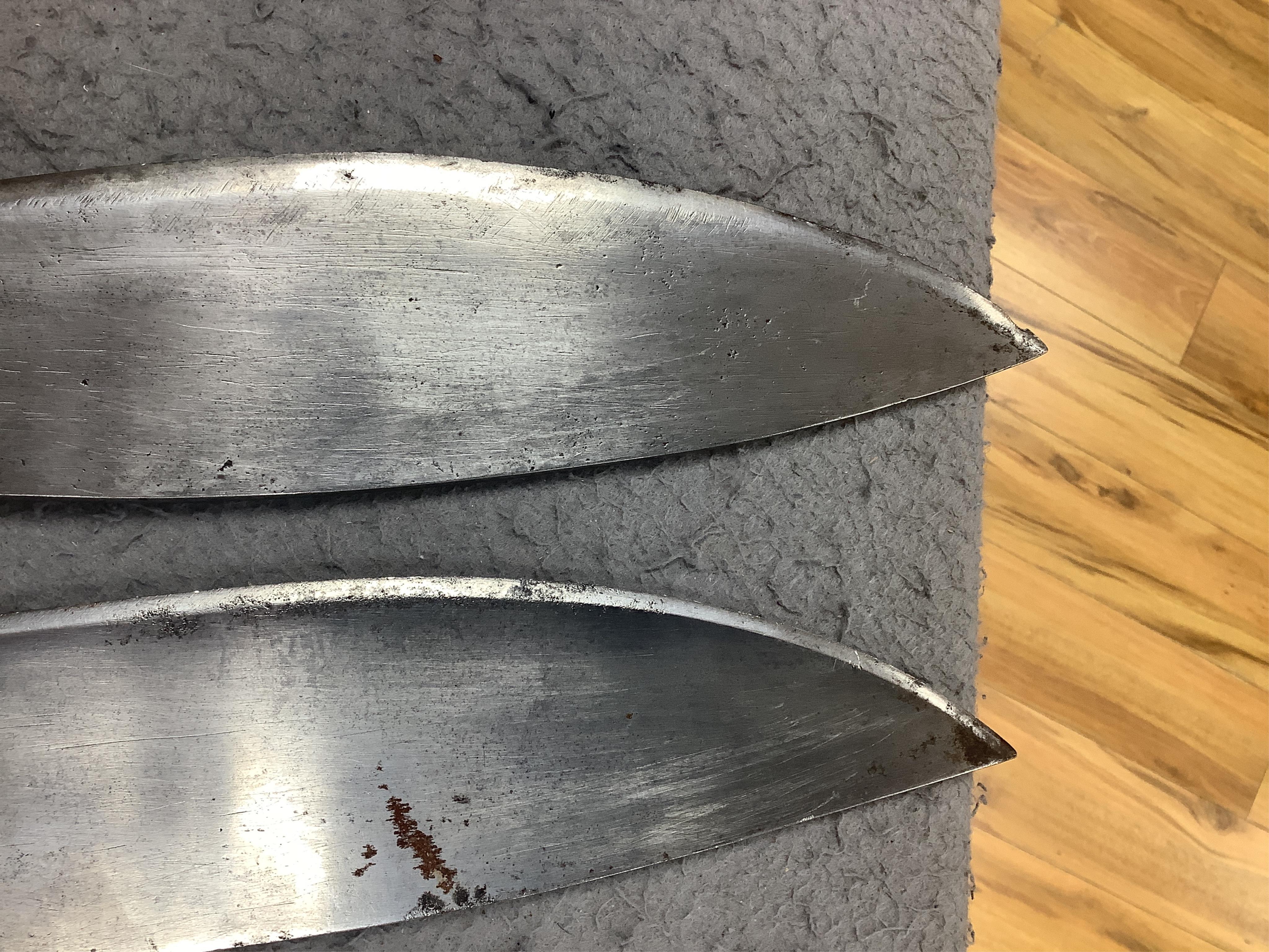 Two military kukri; one with blade stamped with British government ownership mark and issue date February 1916, with wooden handle, no scabbard and another almost identical with board of ordnance mark issued March 1917.